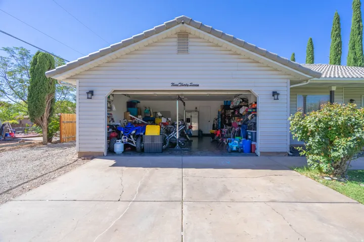 Spacious two-car garage with overhead door, finished interior walls, and ample storage capacity
