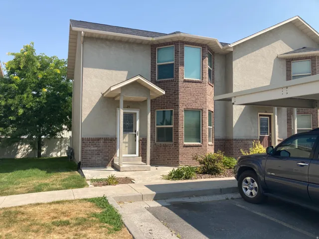 Stucco and brick exterior with a prominent bay window