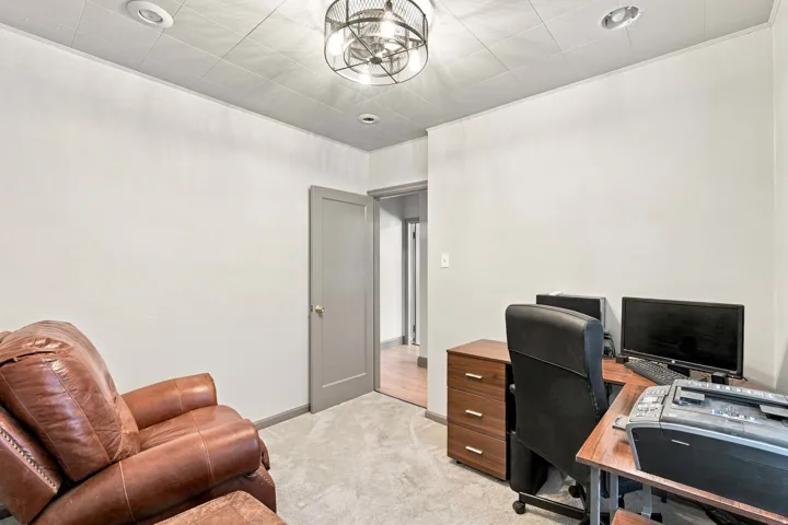 Neutral wall color, recessed lighting, and a contemporary ceiling fixture