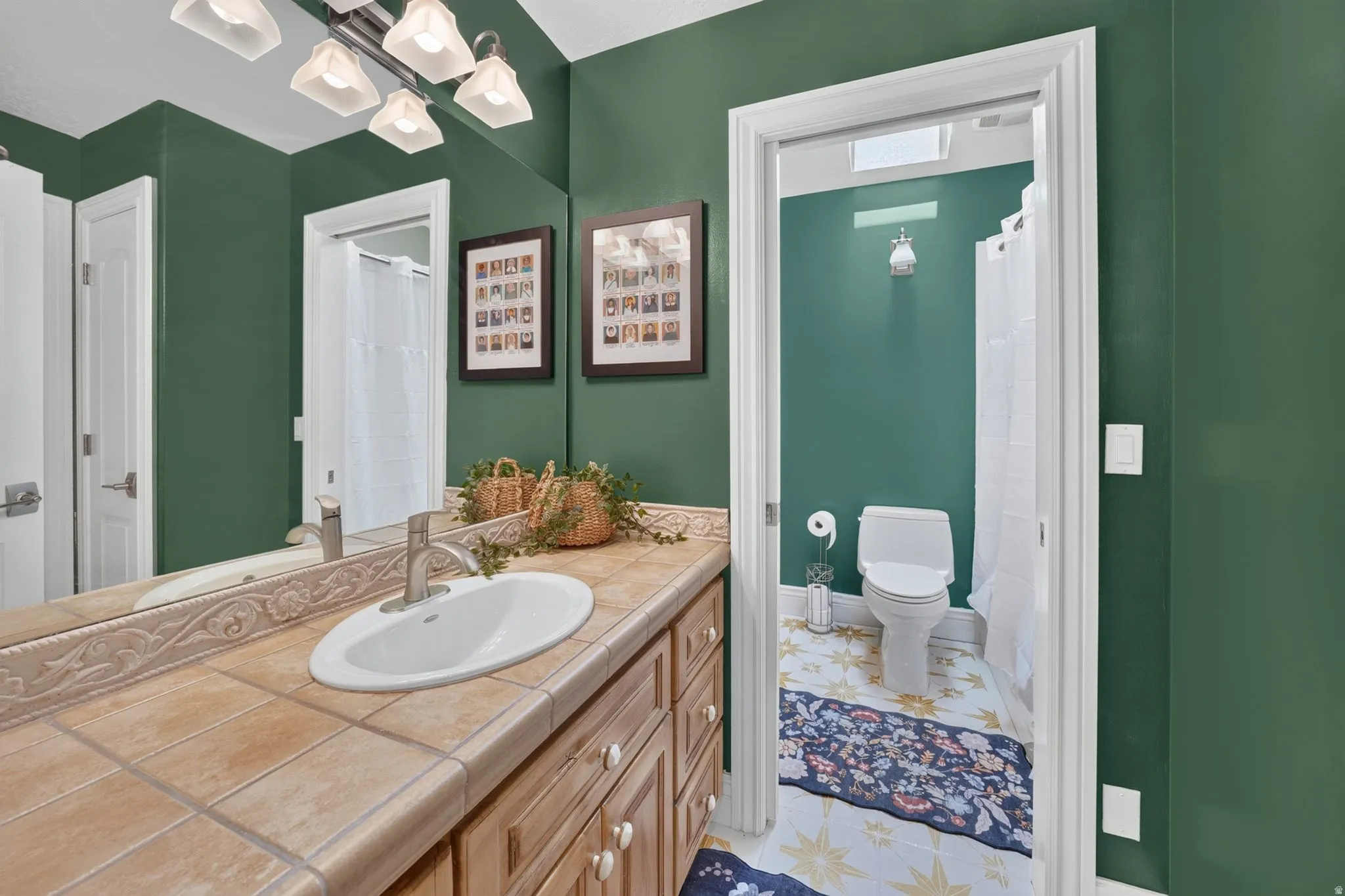Vanity with tile countertop, undermount sink, and brushed nickel faucet