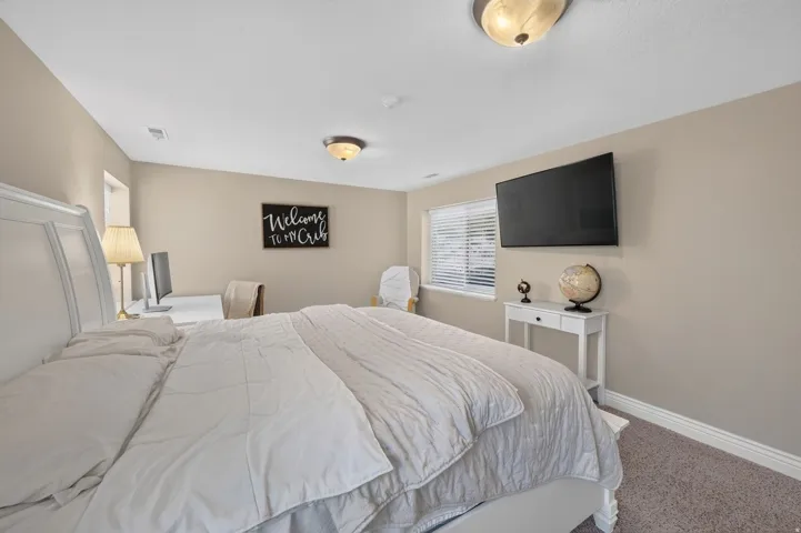 Neutral-toned walls complement the textured carpeting