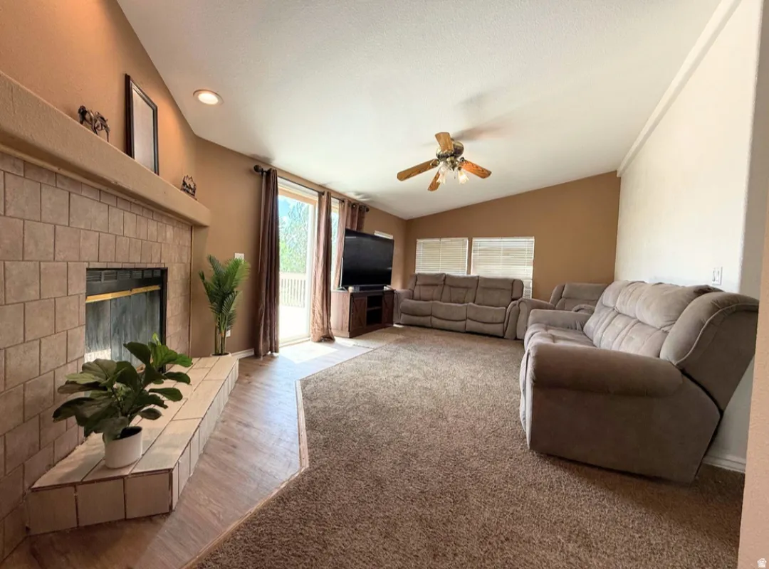 Spacious living area featuring a tile fireplace with hearth.