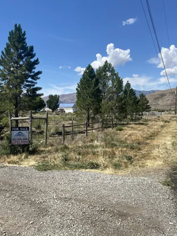 Gravel road access with a wooden fence