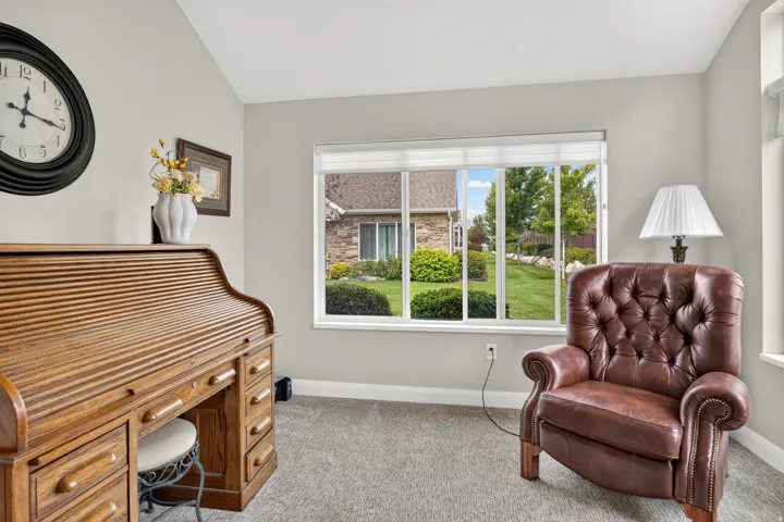 Light gray wall paint, large picture window, and light gray carpeting