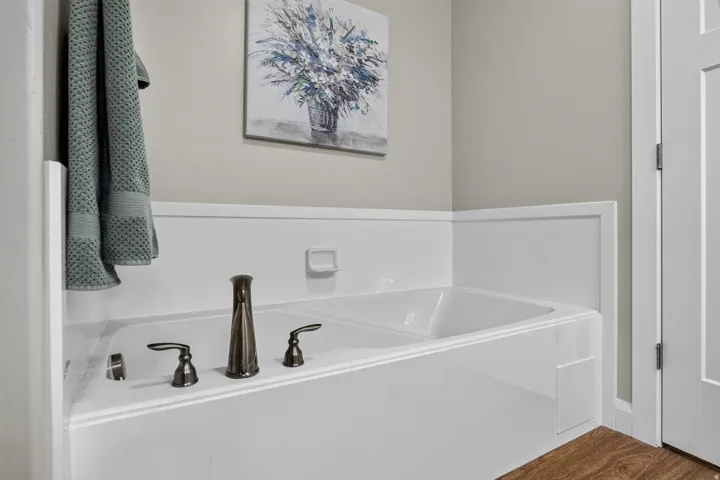 Built-in soaking tub with dark bronze fixtures
