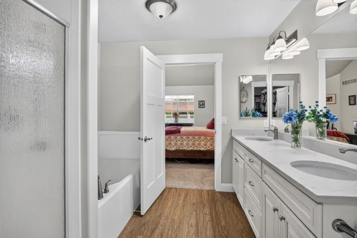 Double vanity with undermount sinks and light-toned countertops