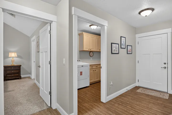 Entryway featuring wood-finish flooring, a white paneled door, and a flush mount ceiling light