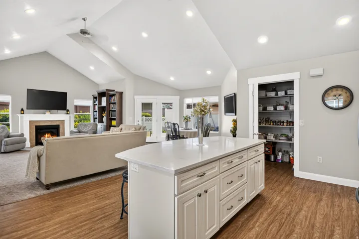 Kitchen island with white cabinetry and light-colored countertop