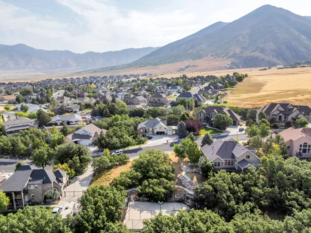 Residential neighborhood featuring established homes, mature trees, and a mountain backdrop