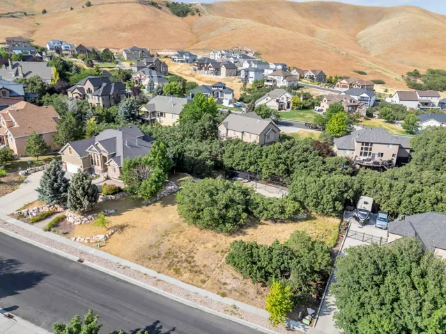 Spacious property with a defined building envelope, surrounded by mature trees, and positioned within a developed residential area