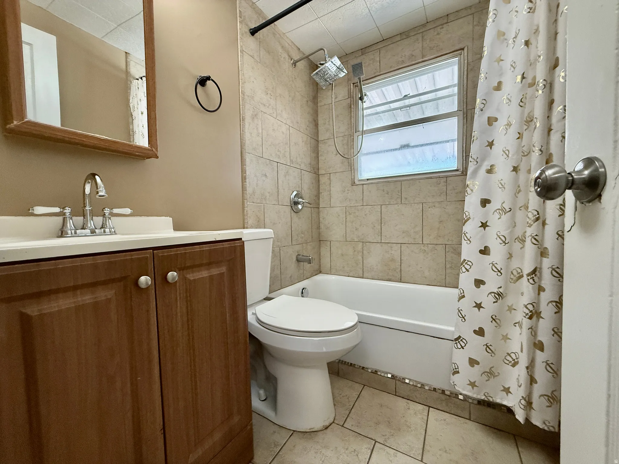 Wood-finish vanity with a white countertop and chrome faucet