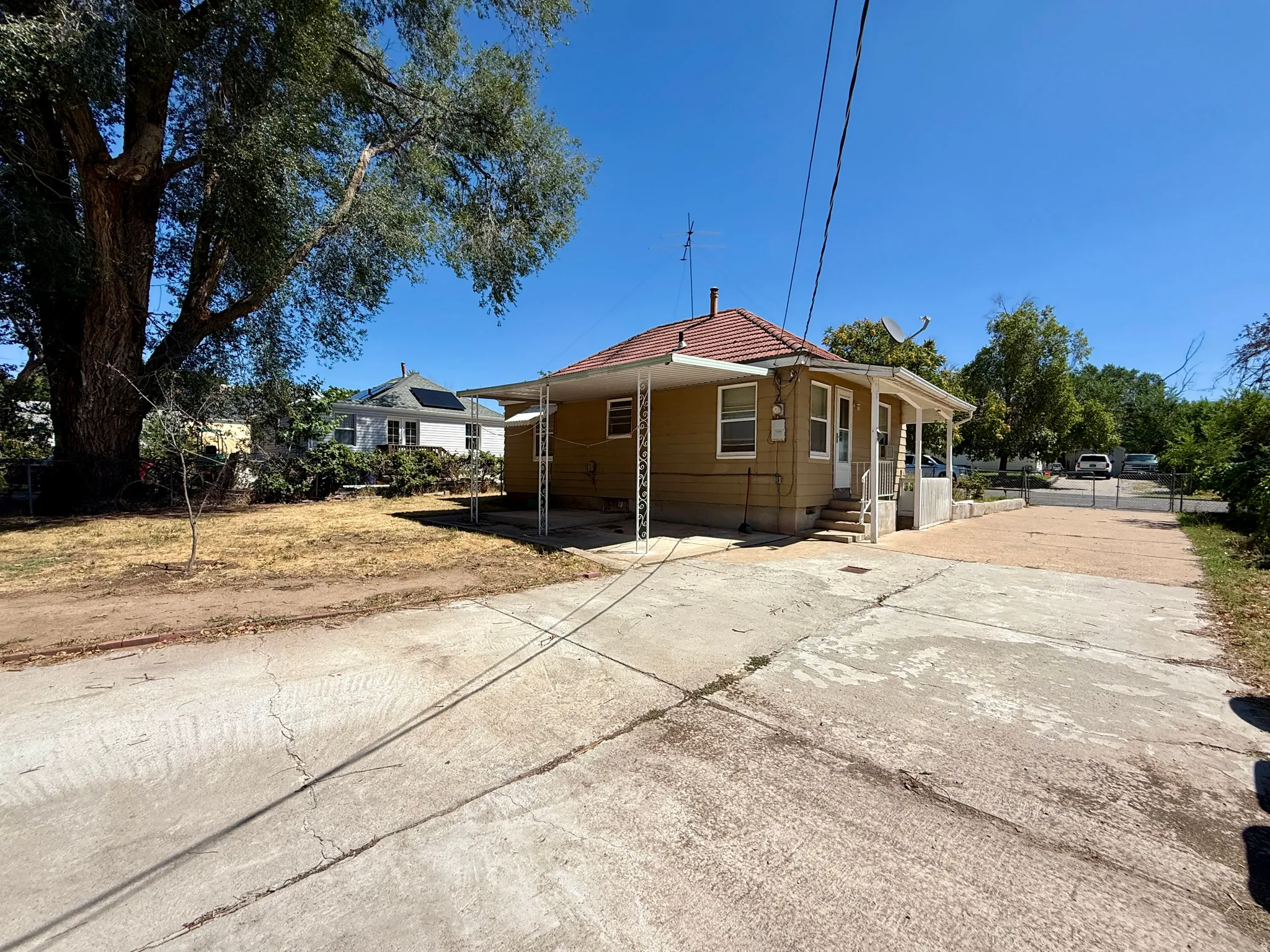 Single-story home with a tan exterior and a red tile roof