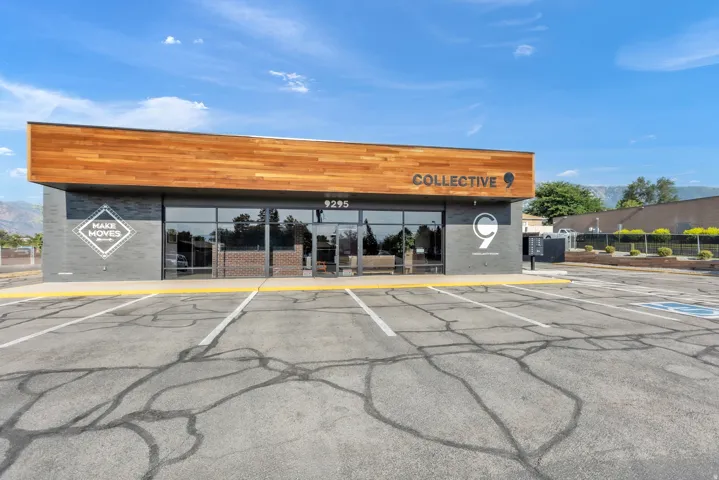 Modern commercial facade featuring a wood-finish accent band and large storefront windows
