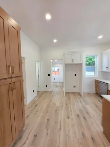Recessed lighting illuminates the wood-finish flooring
