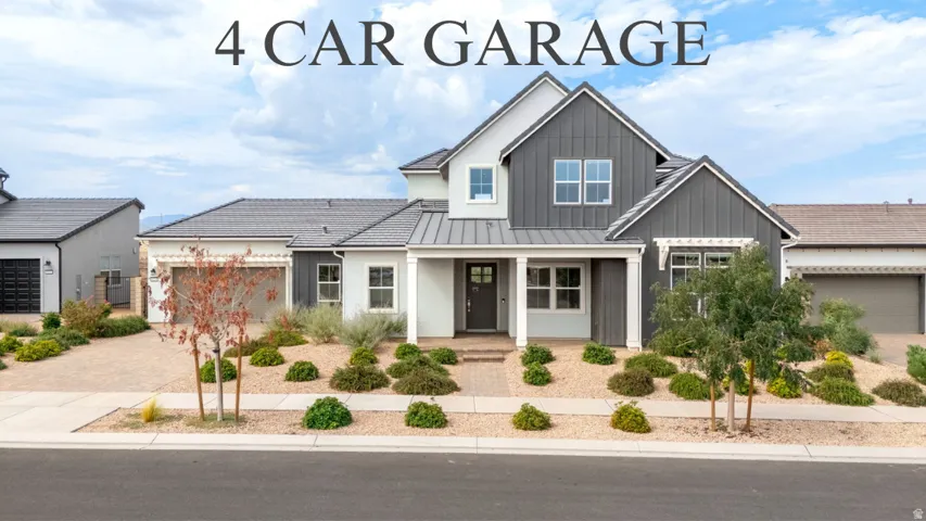 Contemporary exterior featuring mixed siding, a covered entry, and a multi-car garage