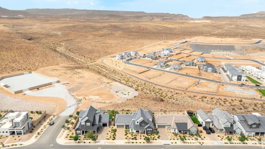 Modern desert community with varied architectural styles, new construction homes, and developing infrastructure