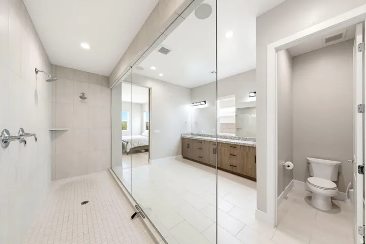 Expansive walk-in shower with dual showerheads and a tiled floor