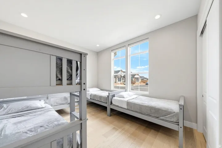 Light-toned wood-finish flooring with recessed lighting