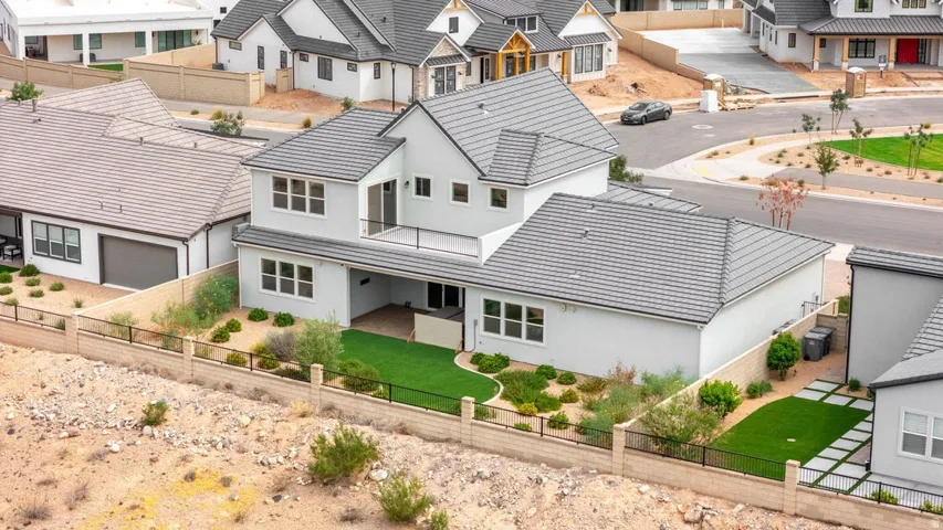 Two-story residence with a gray tile roof and light-colored siding