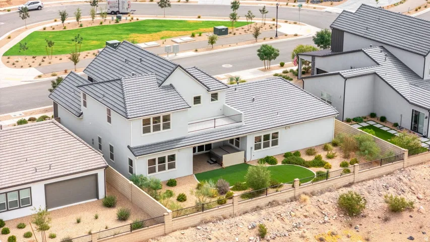 Two-story exterior with a gray tile roof and light-colored siding