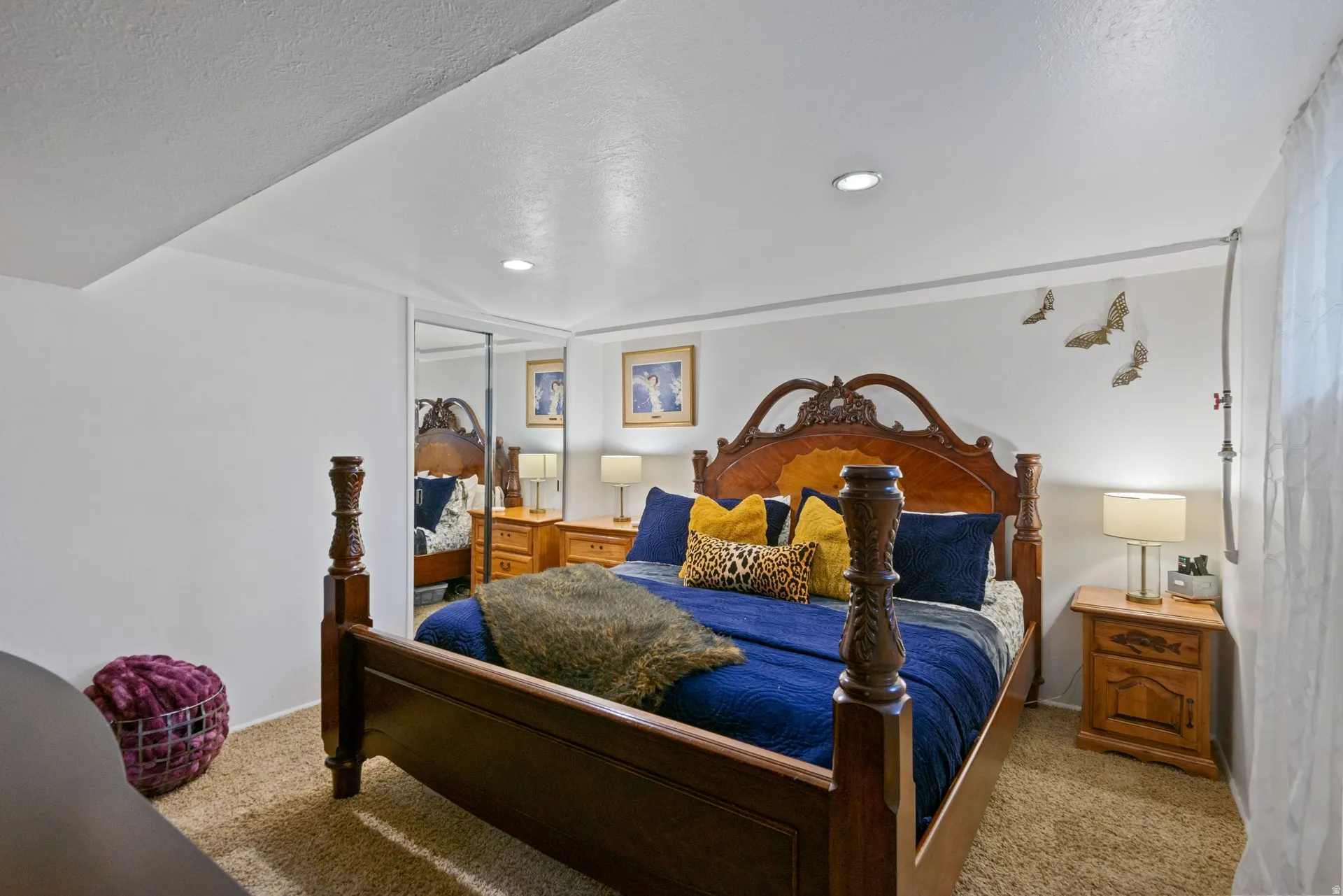 Wall-to-wall carpeting with recessed lighting and mirrored closet doors