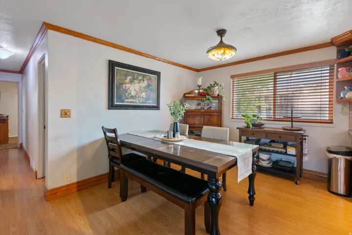 Wood-finish flooring with coordinating wood trim and crown molding