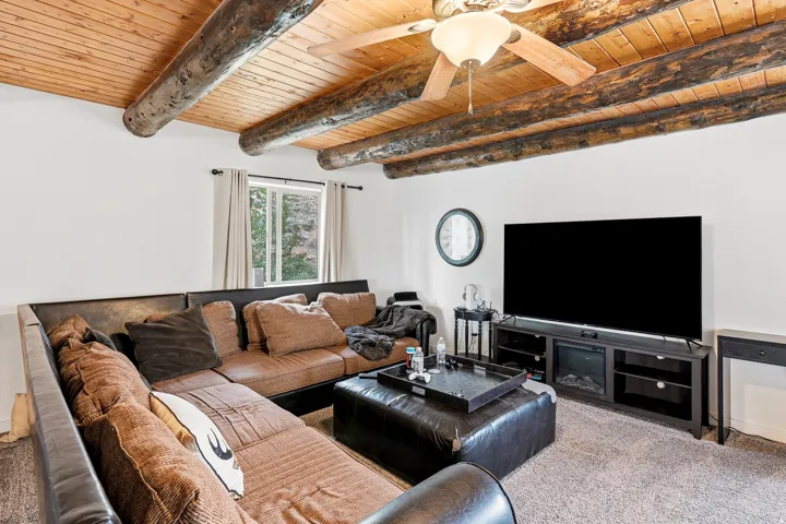 Exposed wood beam ceiling with tongue-and-groove paneling