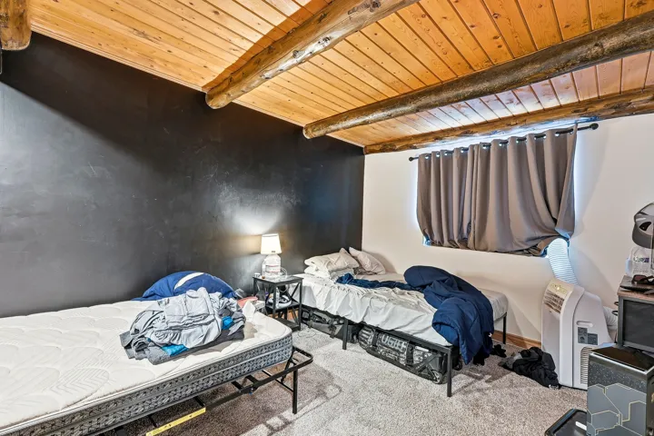 Wood-paneled ceiling with exposed wood beams
