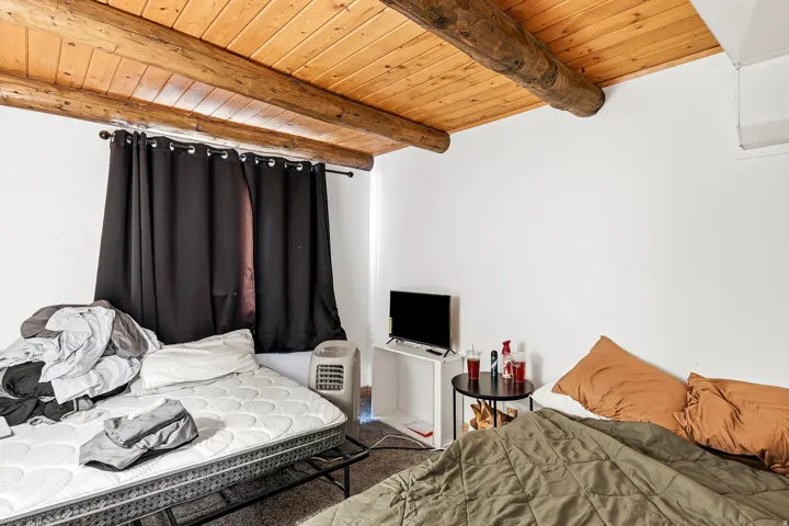 Wood-paneled ceiling with exposed wood beams