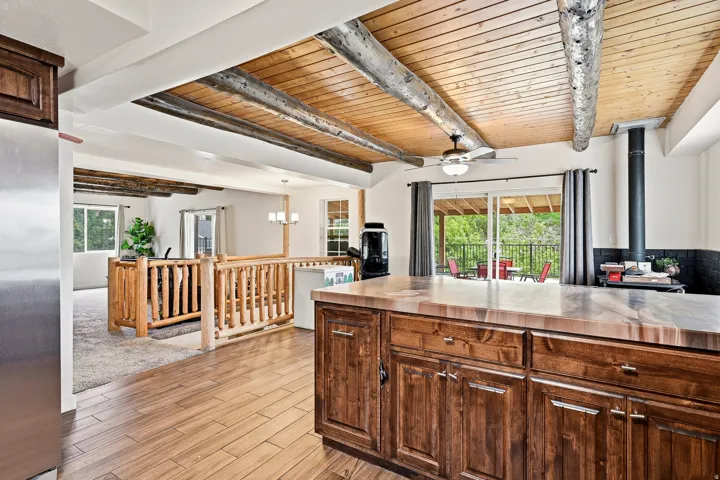 Wood-finish flooring with a rustic wood-beamed ceiling