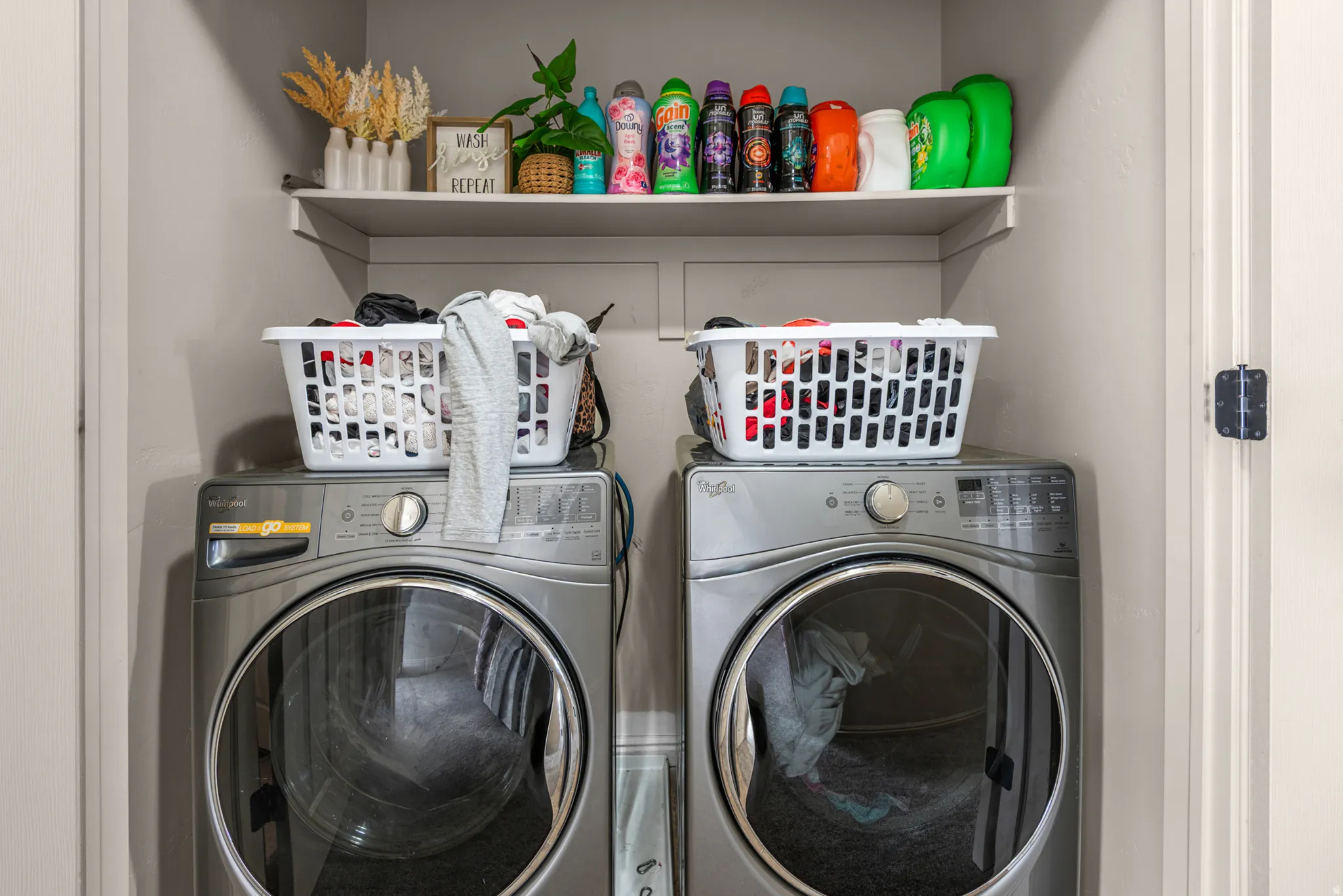 Built-in shelving, two front-load washing machines, and ample storage space