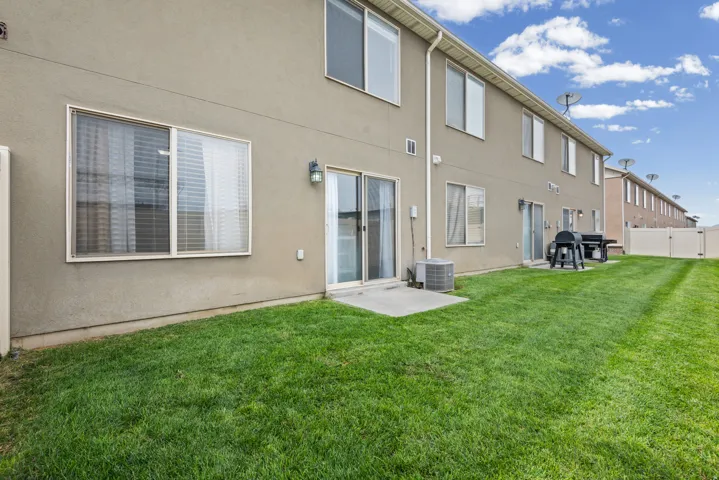 Expansive green lawn with a privacy fence