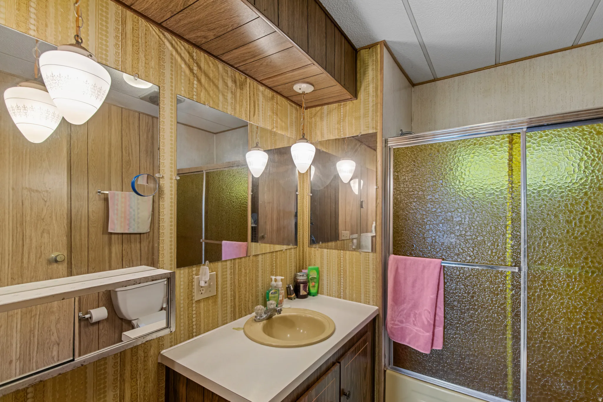 Wood-finish wall paneling, ceiling paneling, and vanity cabinetry