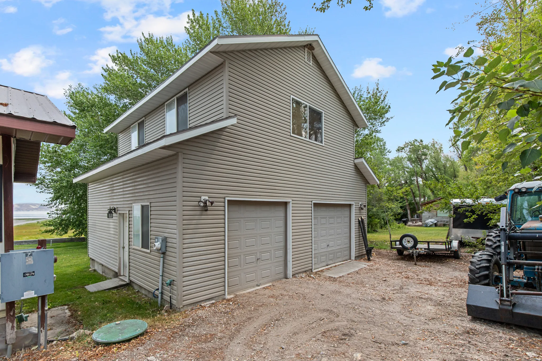 Two-story structure featuring horizontal siding and a dual garage