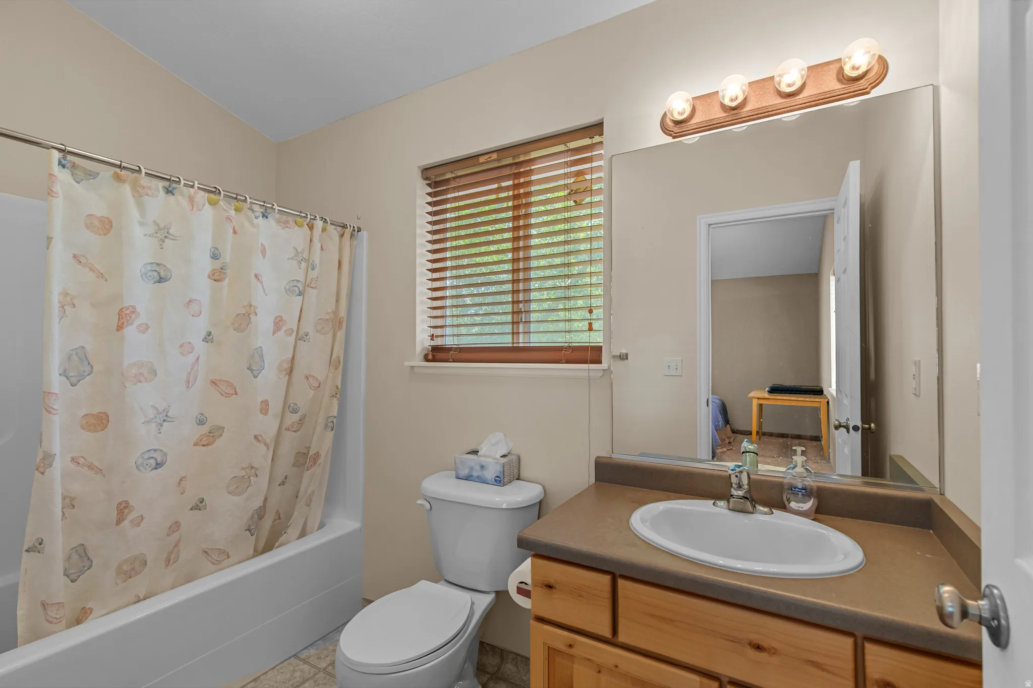 Wood-finish vanity with an integrated sink and countertop