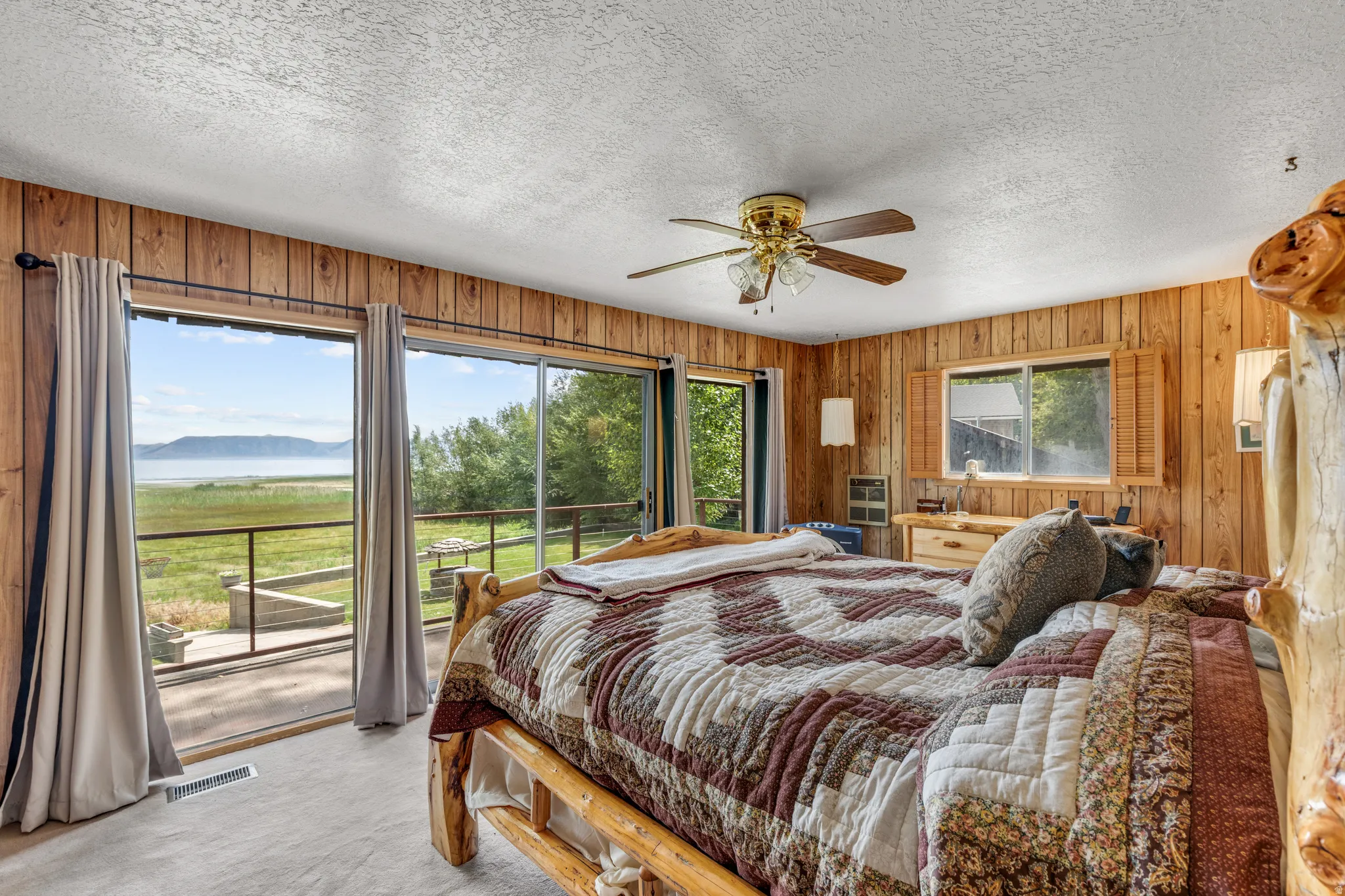 Wood-paneled walls and ceiling fan with integrated lighting