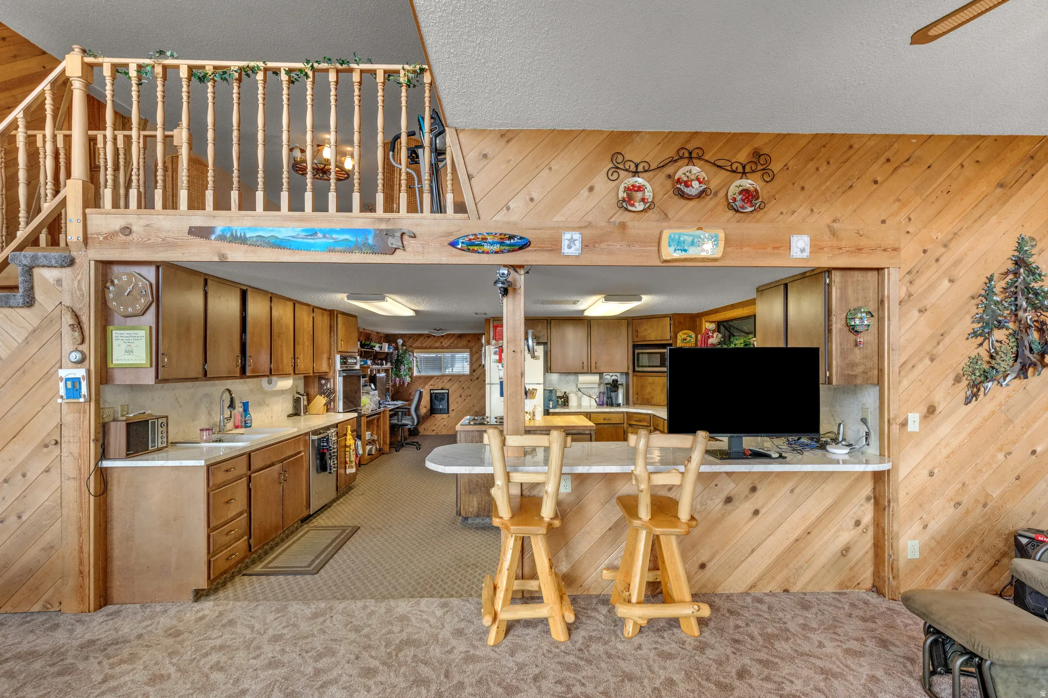Open-concept kitchen with wood cabinetry and a pass-through counter