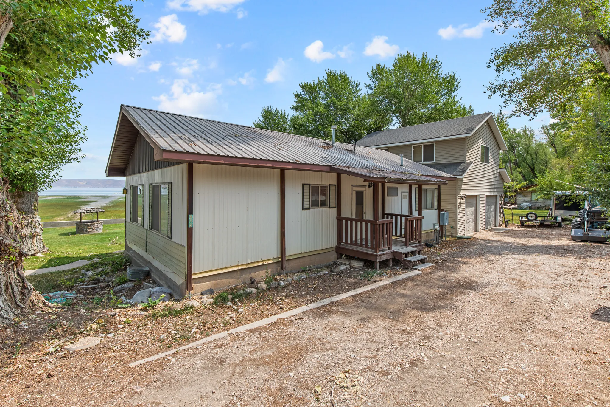 Single-story residence featuring a metal roof, covered porch, and multi-pane windows