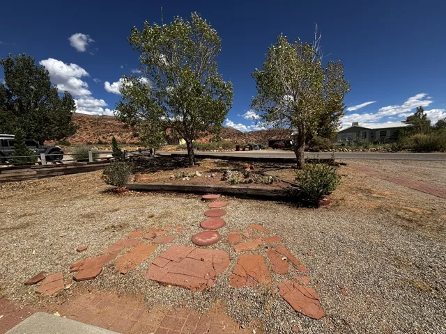 Front yard. Gravel landscaping with a decorative stone pathway