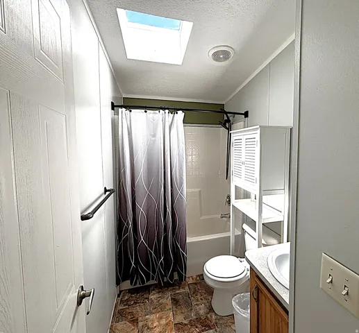 Shower-over-tub combination, skylight, and wood-finish vanity
