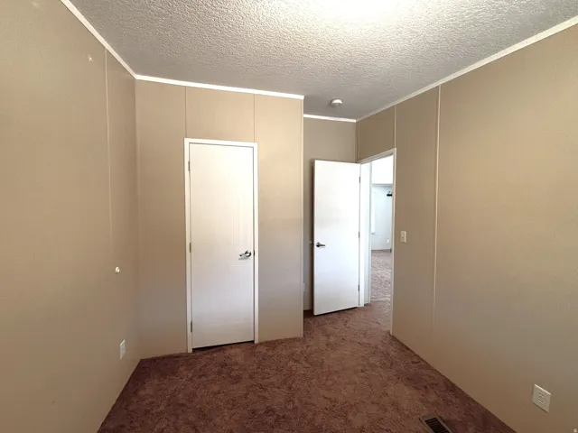 Second bedroom. Neutral tone wall paneling with white trim accents
