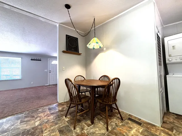 Tiled flooring extends into a designated dining space with a pendant light fixture