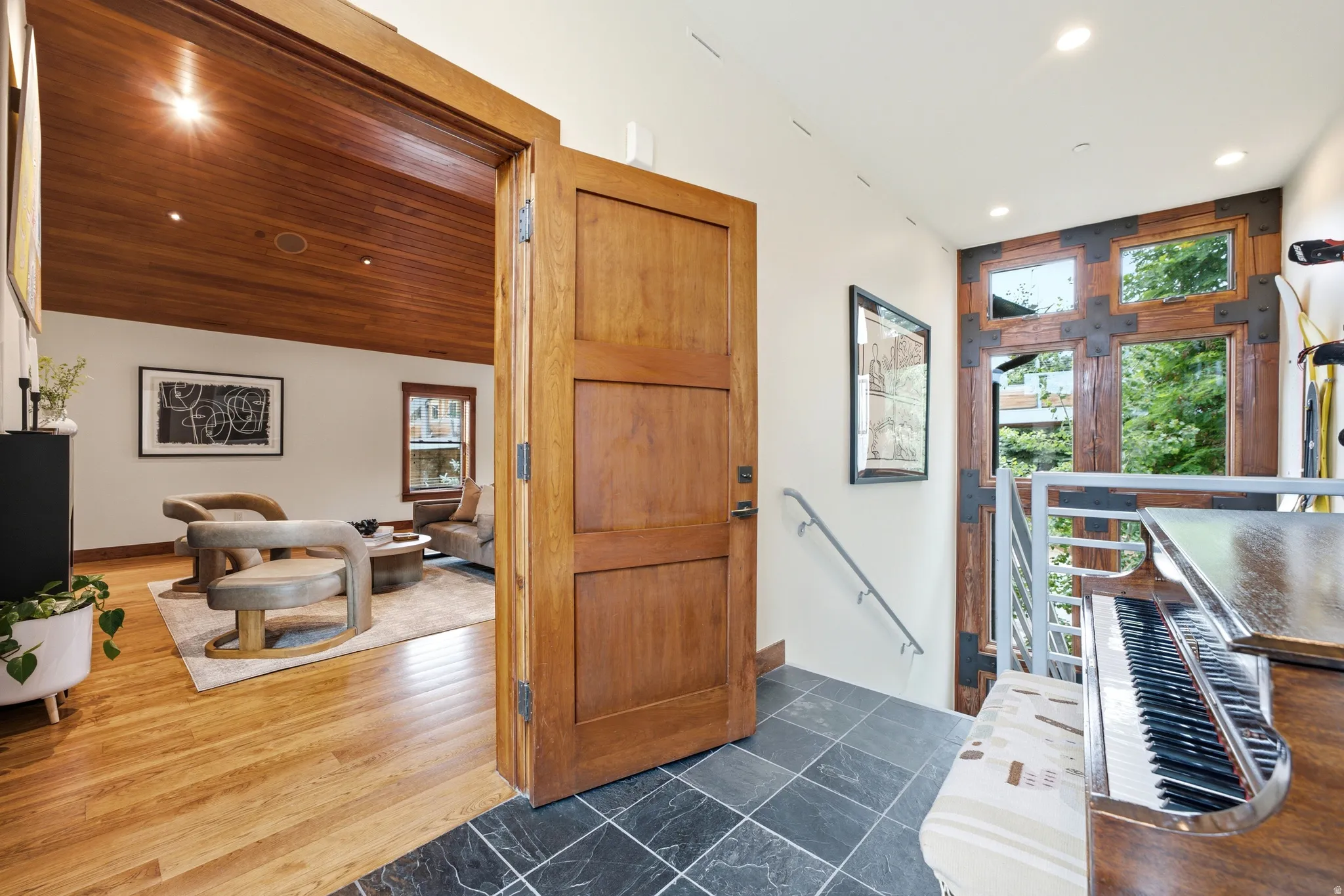 Wood-finish flooring and a wood plank ceiling complement the solid wood door frame