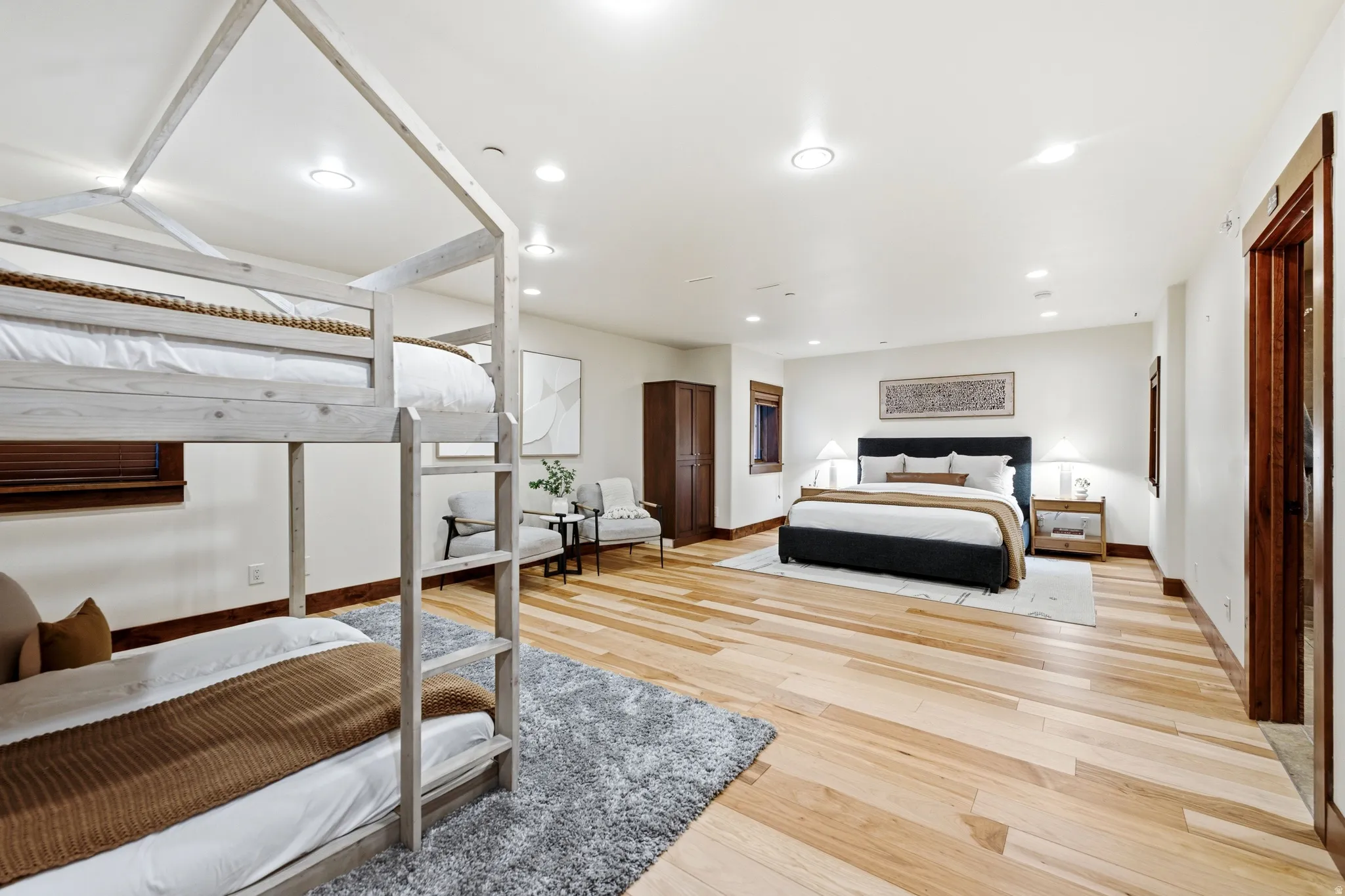 Recessed lighting, wood-finish flooring, wood trim, white walls, and a built-in closet