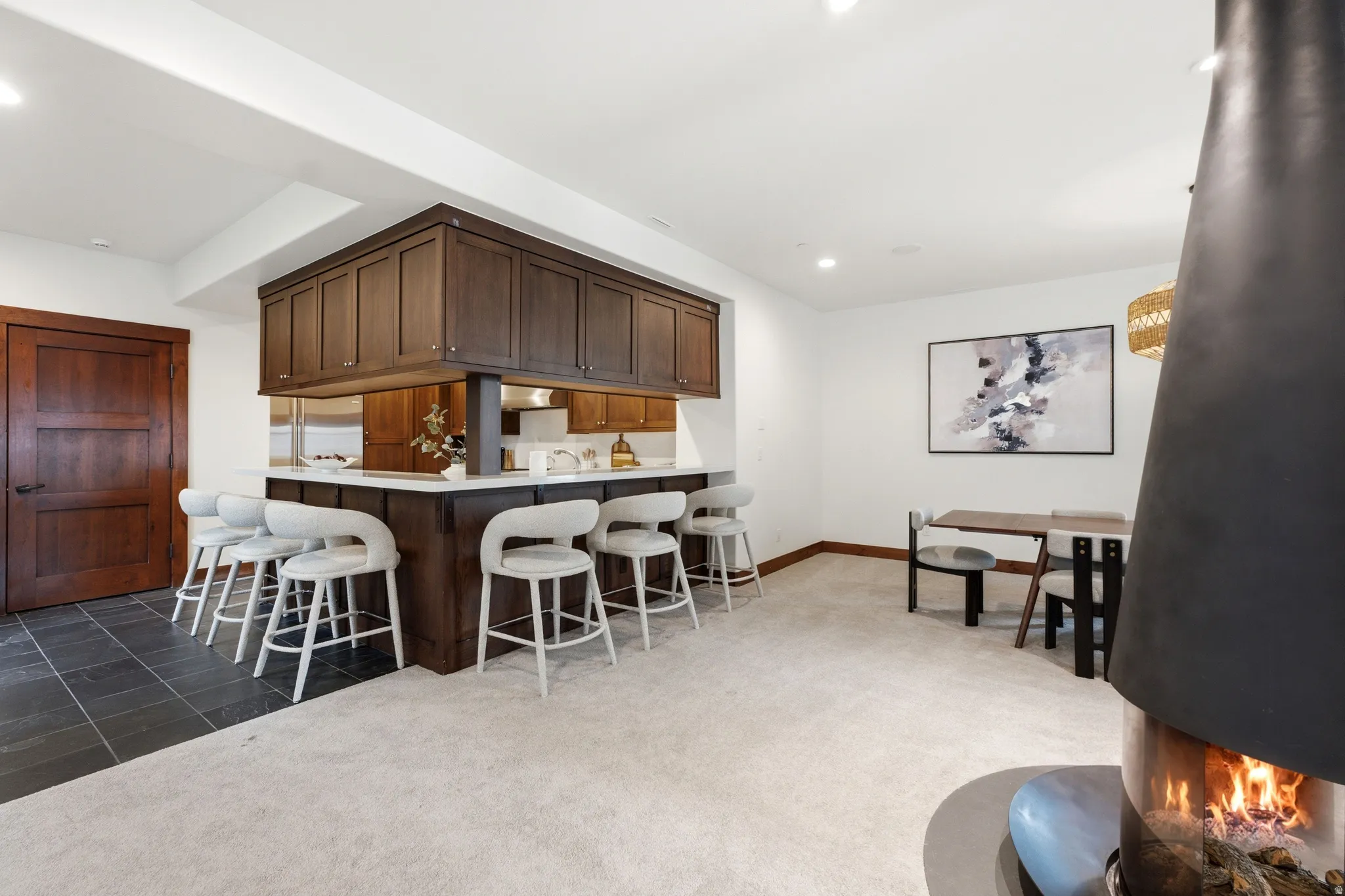 Built-in wet bar with dark wood cabinetry and a light-toned countertop