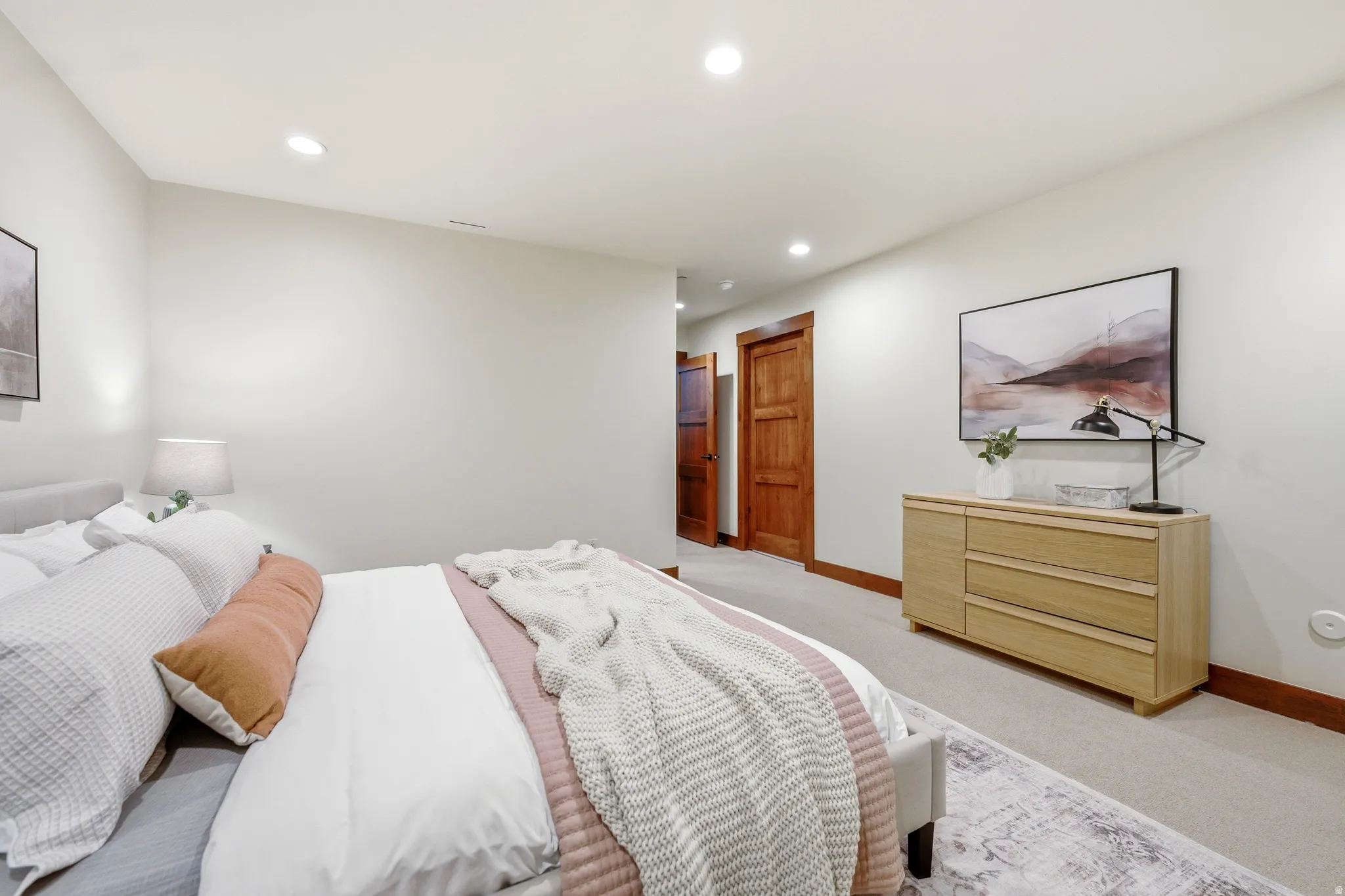 Recessed ceiling lights illuminate neutral-toned walls