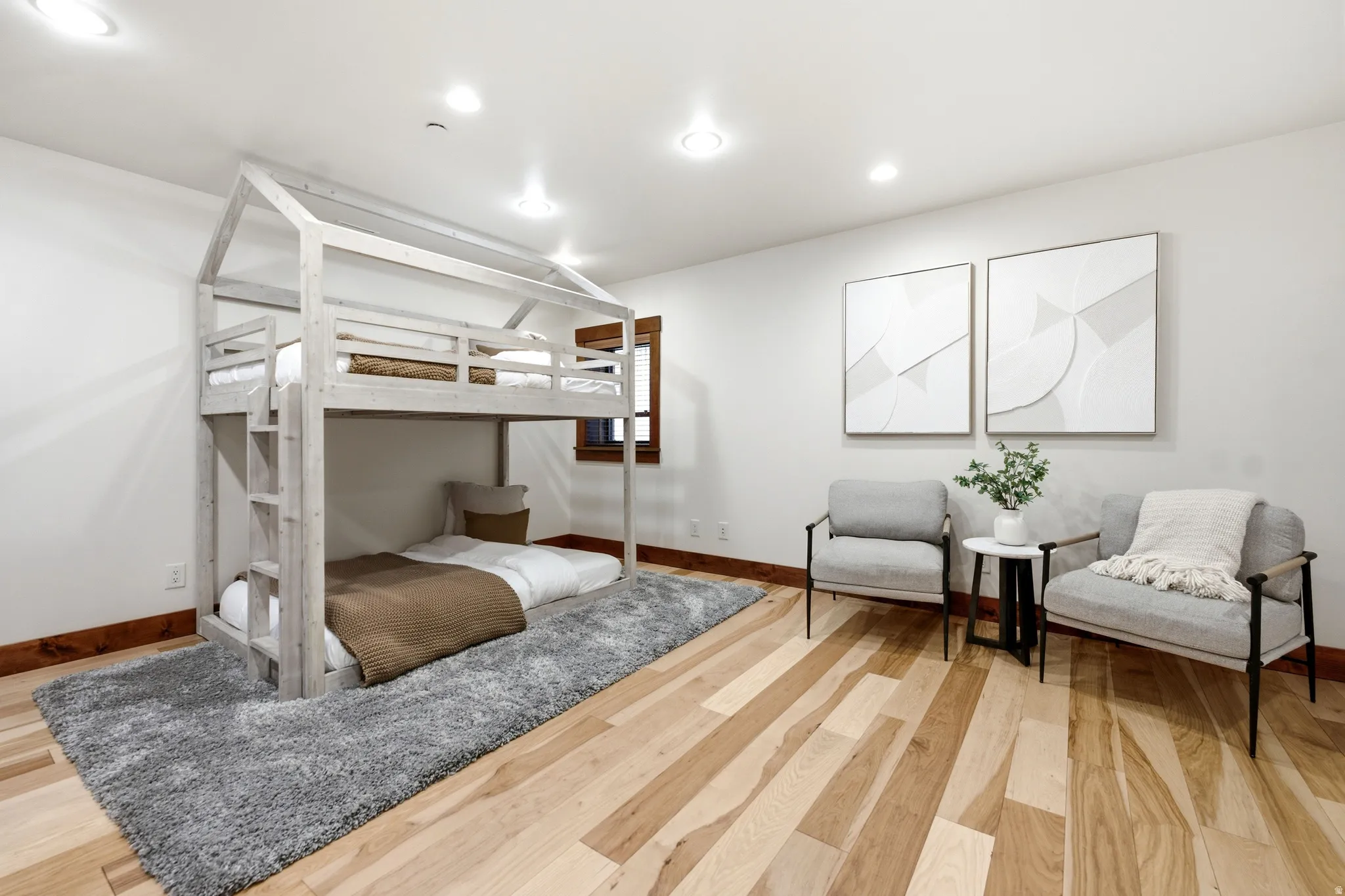 Recessed lighting, light wood-finish flooring, white walls, and wood trim