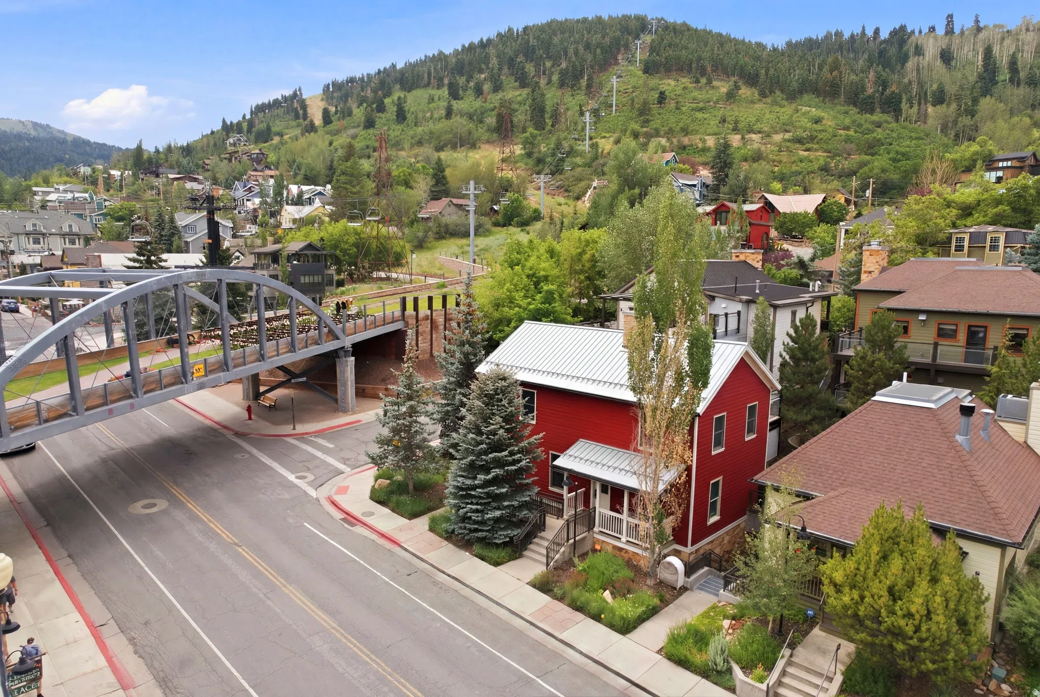 Red exterior with a metal roof and a covered front porch