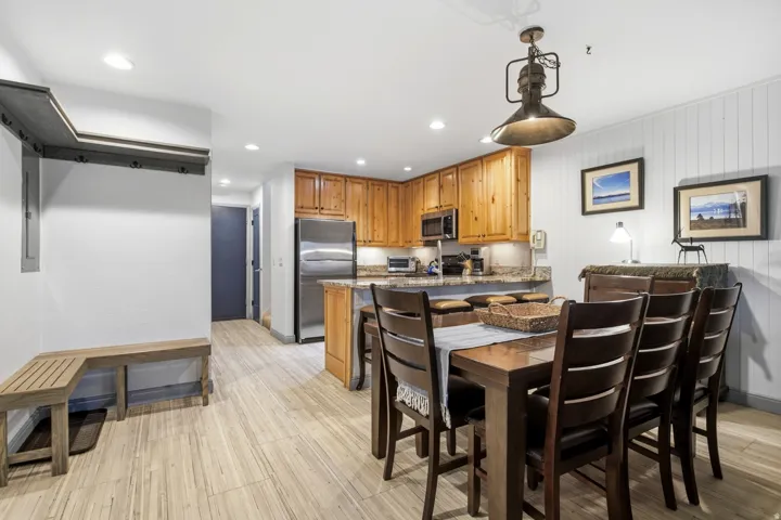 Open-concept kitchen and dining area featuring wood-finish flooring
