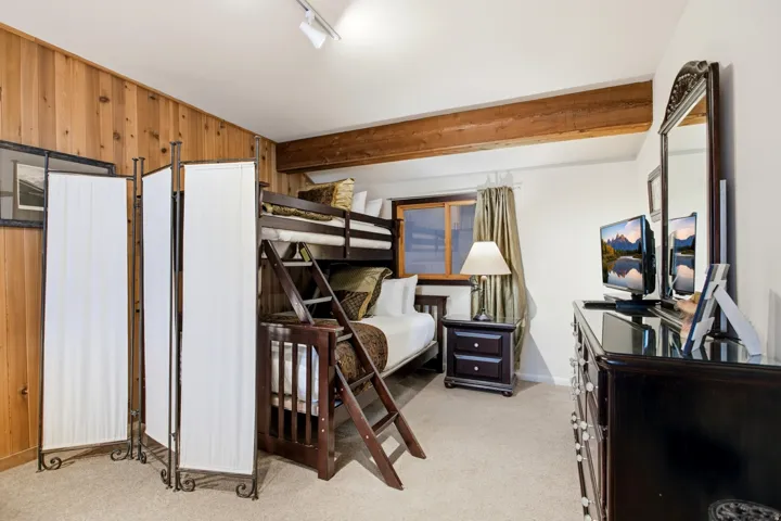 Wood-panel accent wall and exposed wood beam